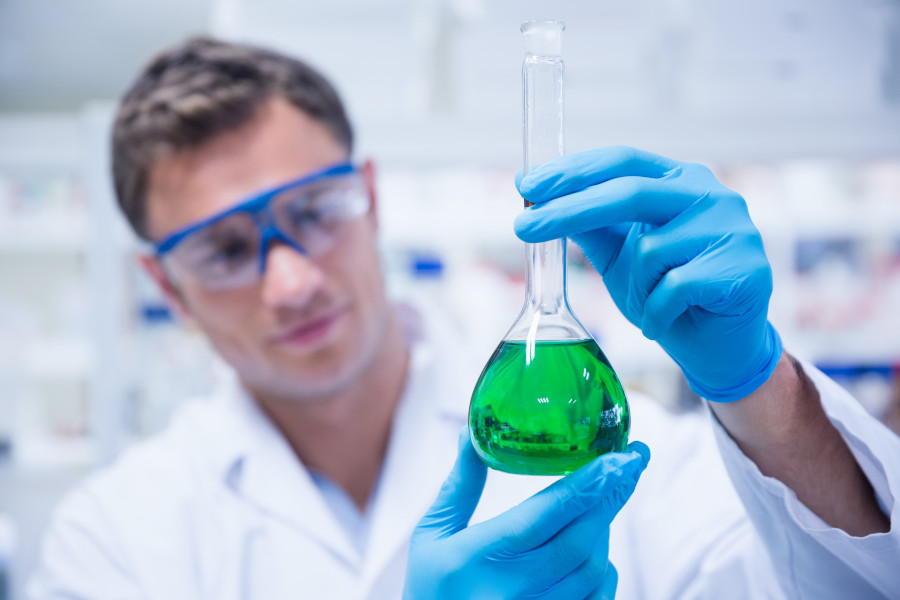 Chemist inspecting a zinc phosphate solution in the Labtech laboratory